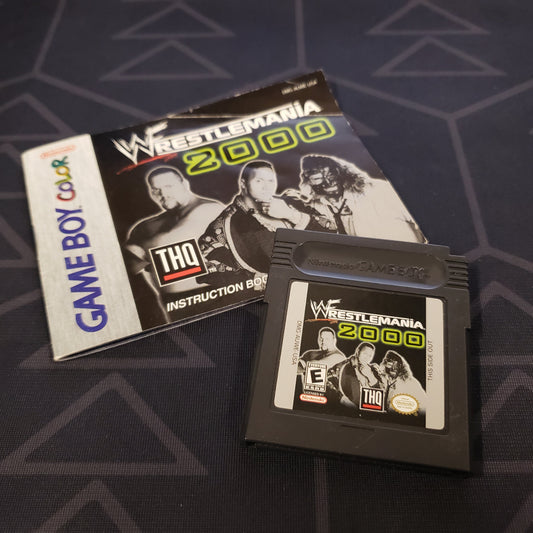 Image shows the manual & cartridge for the video game WWF Wrestlemania 2000 for Nintendo Game Boy Color