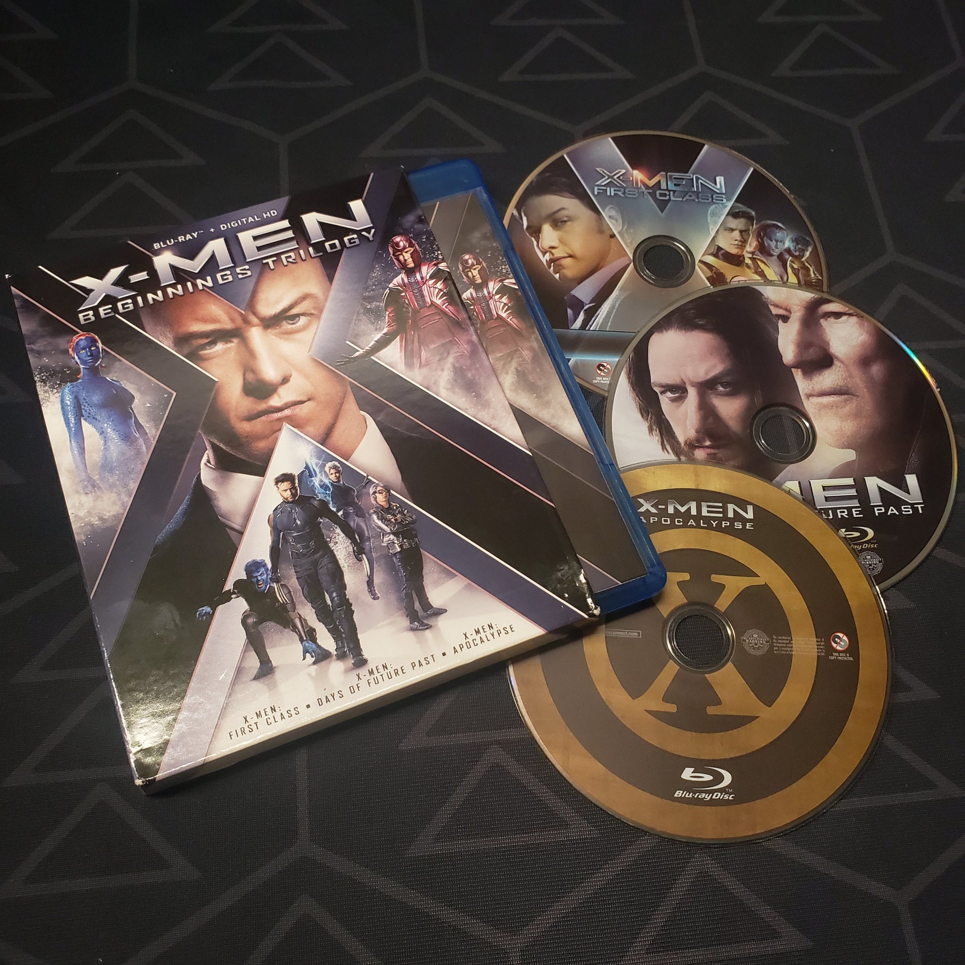 Image shows the case, slipcover & three discs for the movie set of X-Men: Beginnings Trilogy on Blu-Ray
