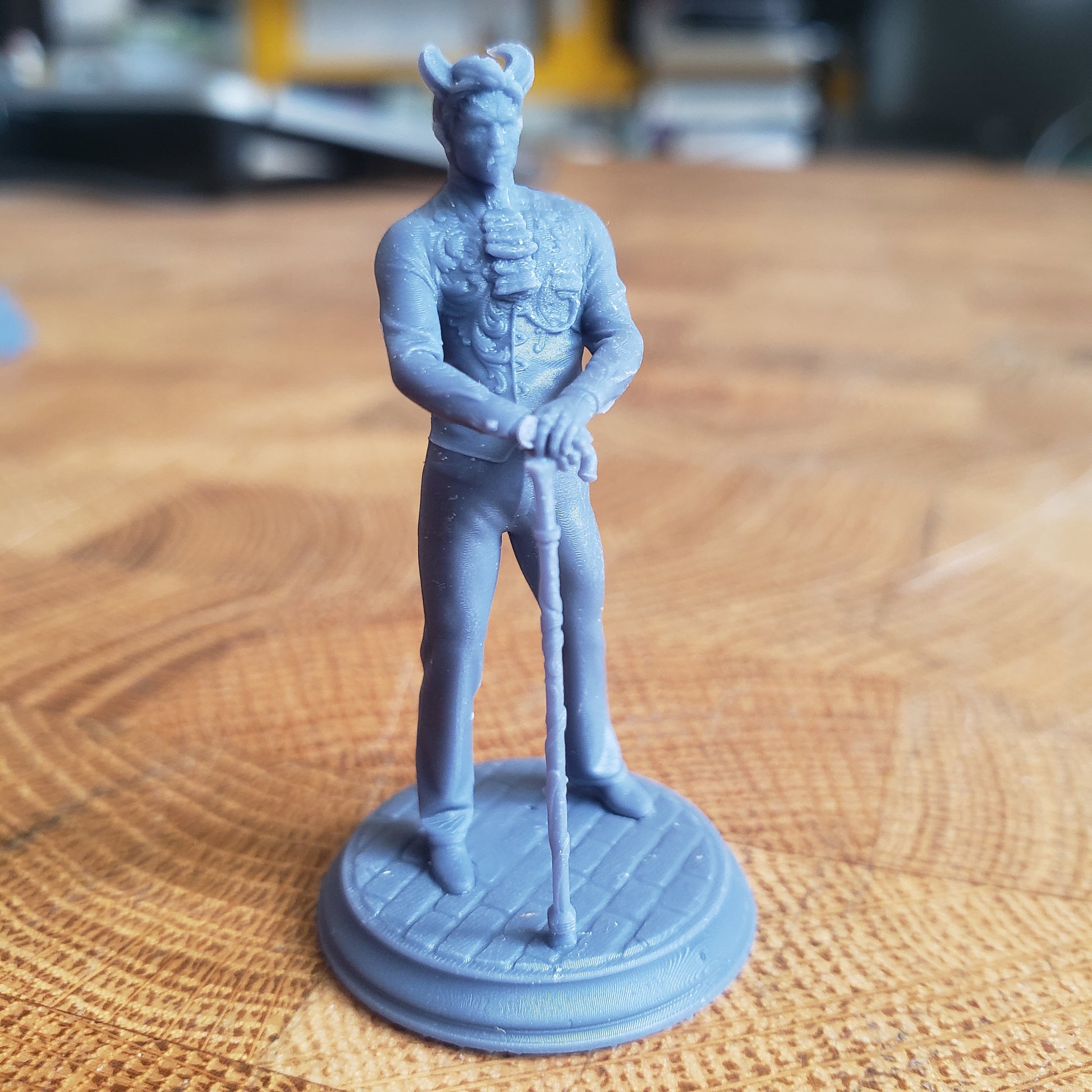 Image is a photo of a 3D printed tiefling noble gaming miniature printed in-house at All Systems Go