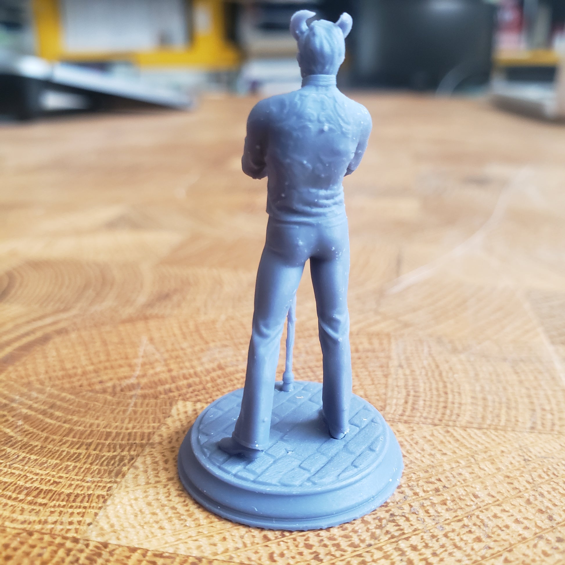 Image is a photo of a 3D printed tiefling noble gaming miniature printed in-house at All Systems Go