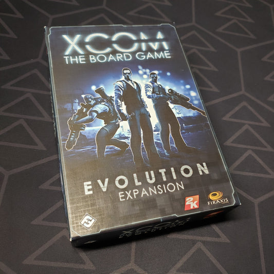 Image shows the front cover of the box of the Evolution expansion for XCOM: The Board Game 
