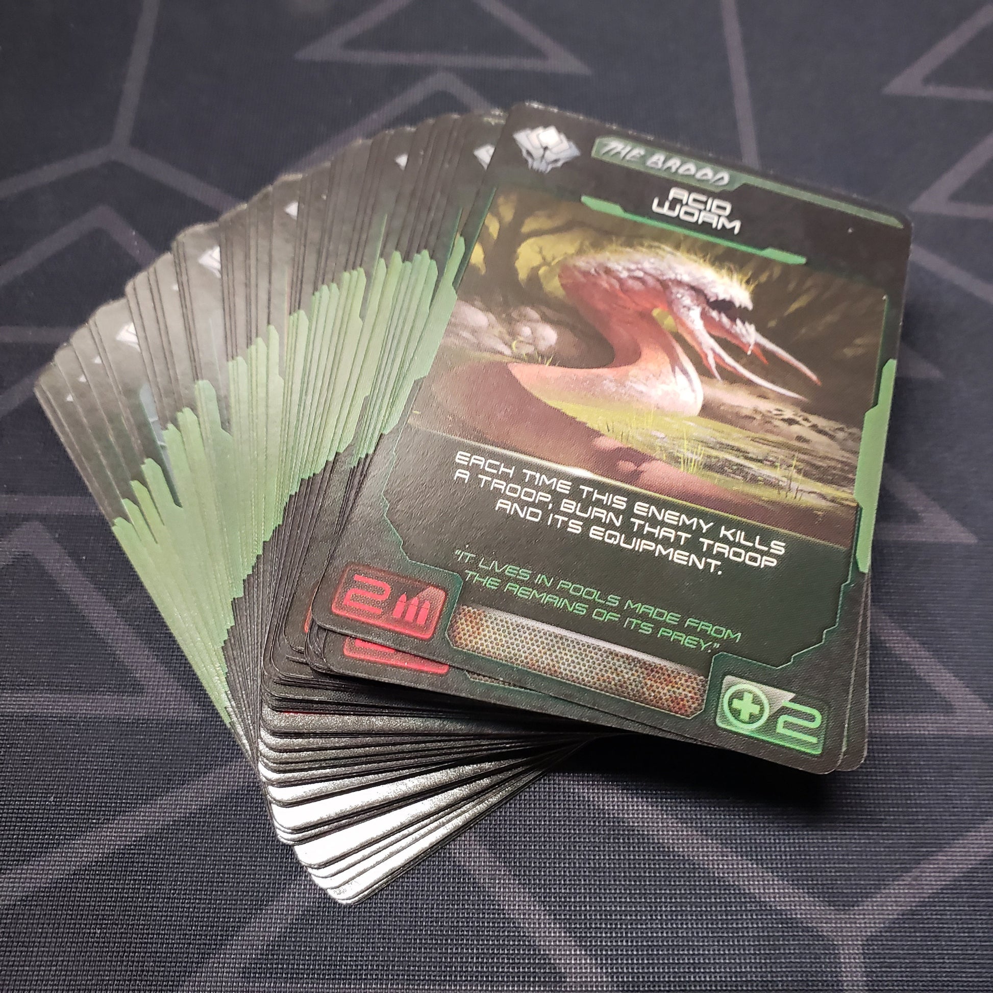 Image shows the fanned-out cards for the Brood expansion for the board game XenoShyft: Dreadmire