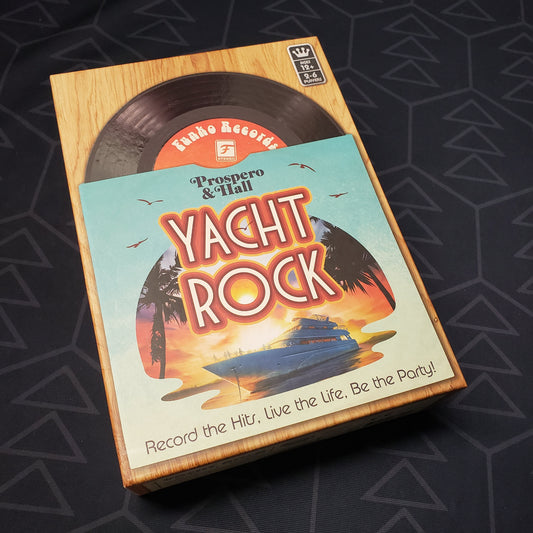 Image shows the front cover of the box for the Yacht Rock card game