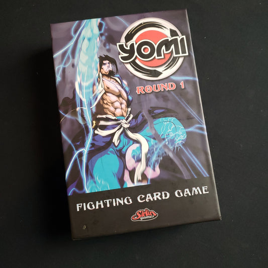Image shows the front cover of the box of the Yomi: Round 1 card game
