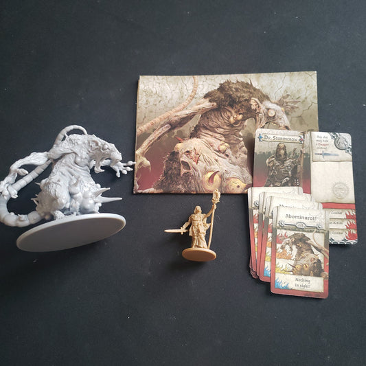 Image shows the miniatures and cards for the Abominarat & Dr. Stormcrow expansion for the board game Zombicide: Black Plague