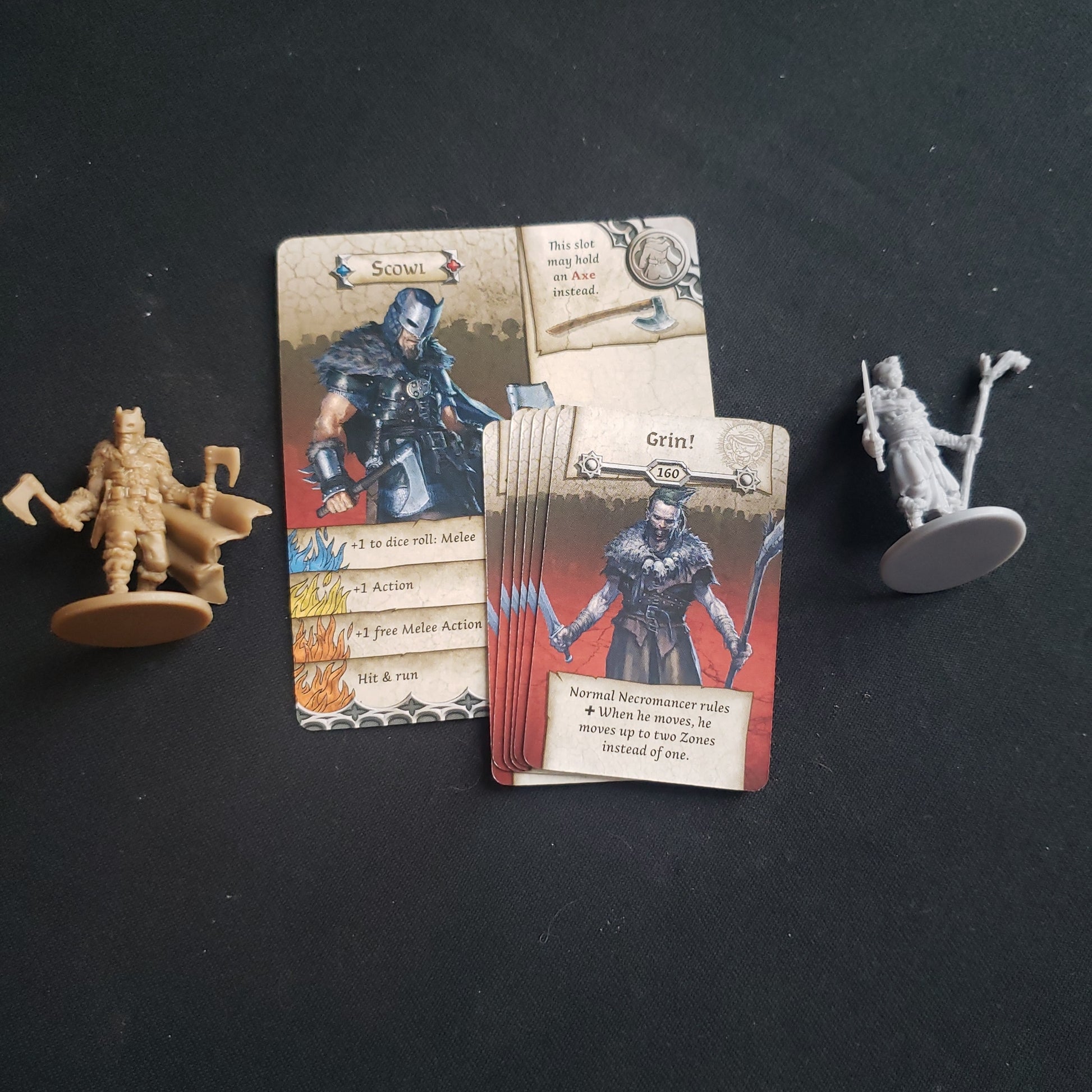 Image shows the miniatures and cards for the Grin & Scowl character expansion for the board game Zombicide: Black Plague