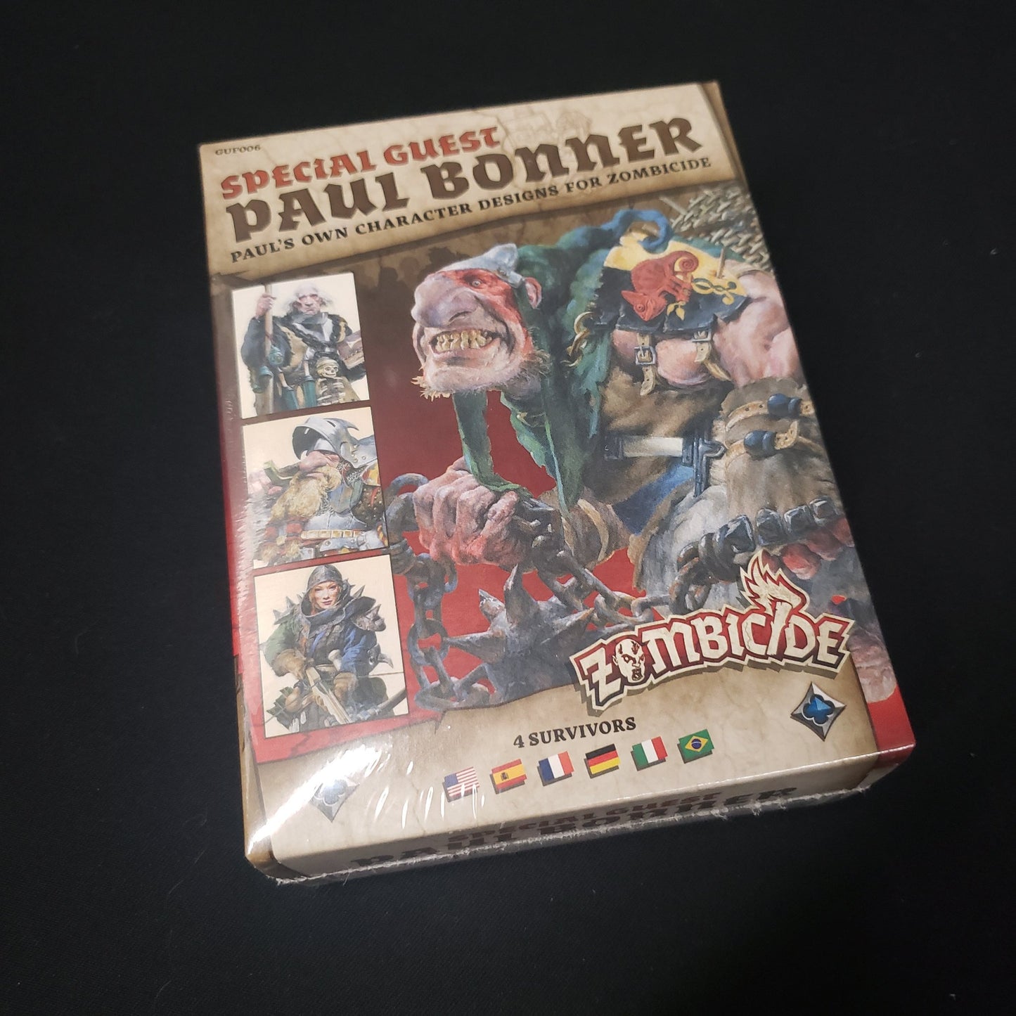 Image shows the front of the box for the Paul Bonnner Special Guest Box expansion for the board game Zombicide: Black Plague