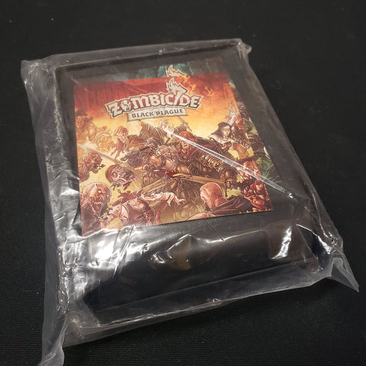 Image shows the collapsible dice tower for the board game Zombicide: Black Plague in its plastic packaging
