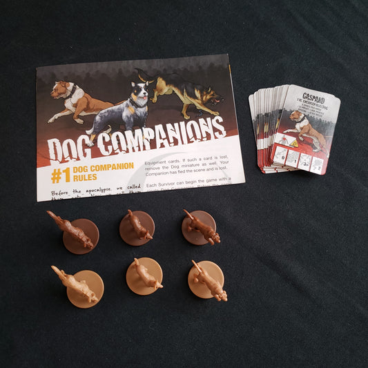 Image shows the instructions, miniatures & cards for the Box Of Dogs expansion for the Zombicide board game
