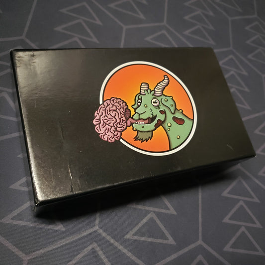 Image shows the front cover of the box for the Zombie Circus Goats card game