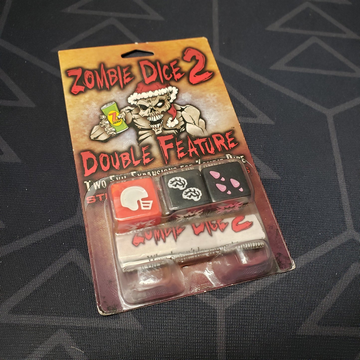Image shows the front cover of the package of the Double Feature expansion for the dice game Zombie Dice