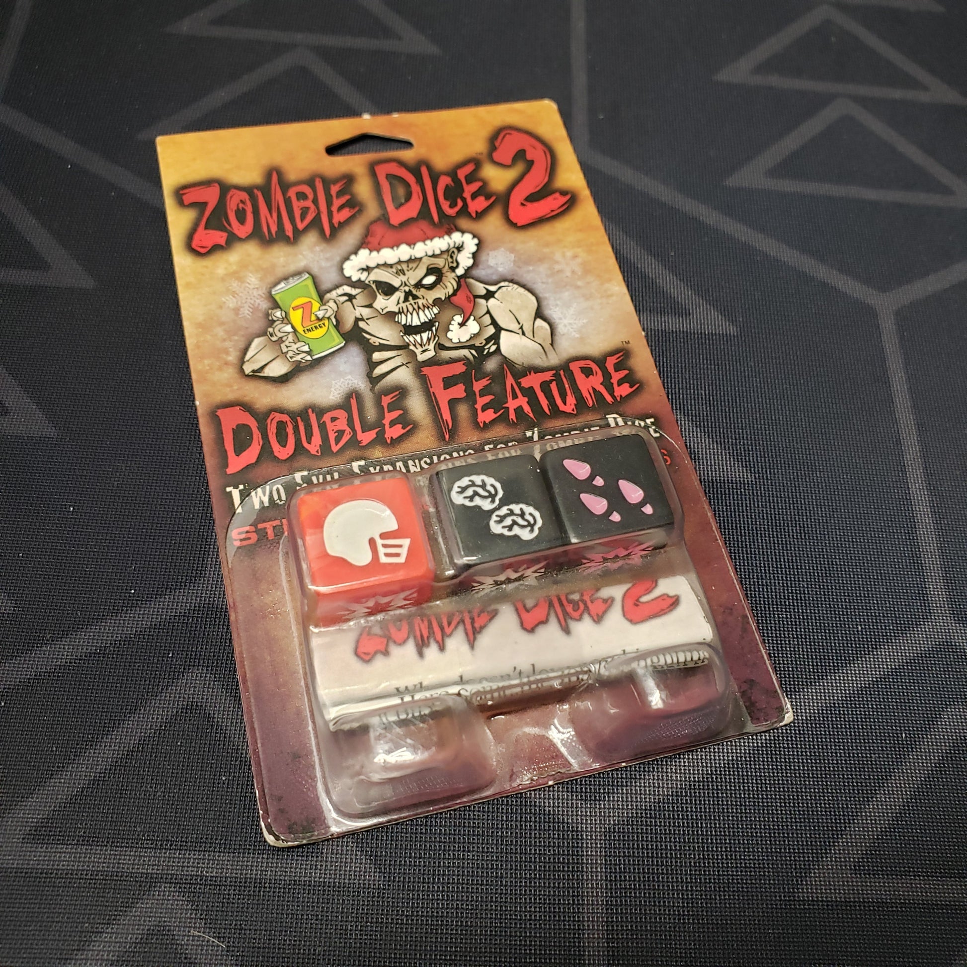 Image shows the front cover of the package of the Double Feature expansion for the dice game Zombie Dice