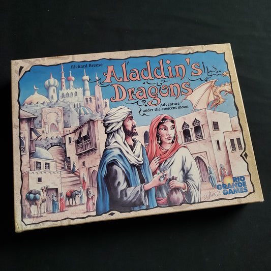 Image shows the front cover of the box of the Aladidn's Dragons board game