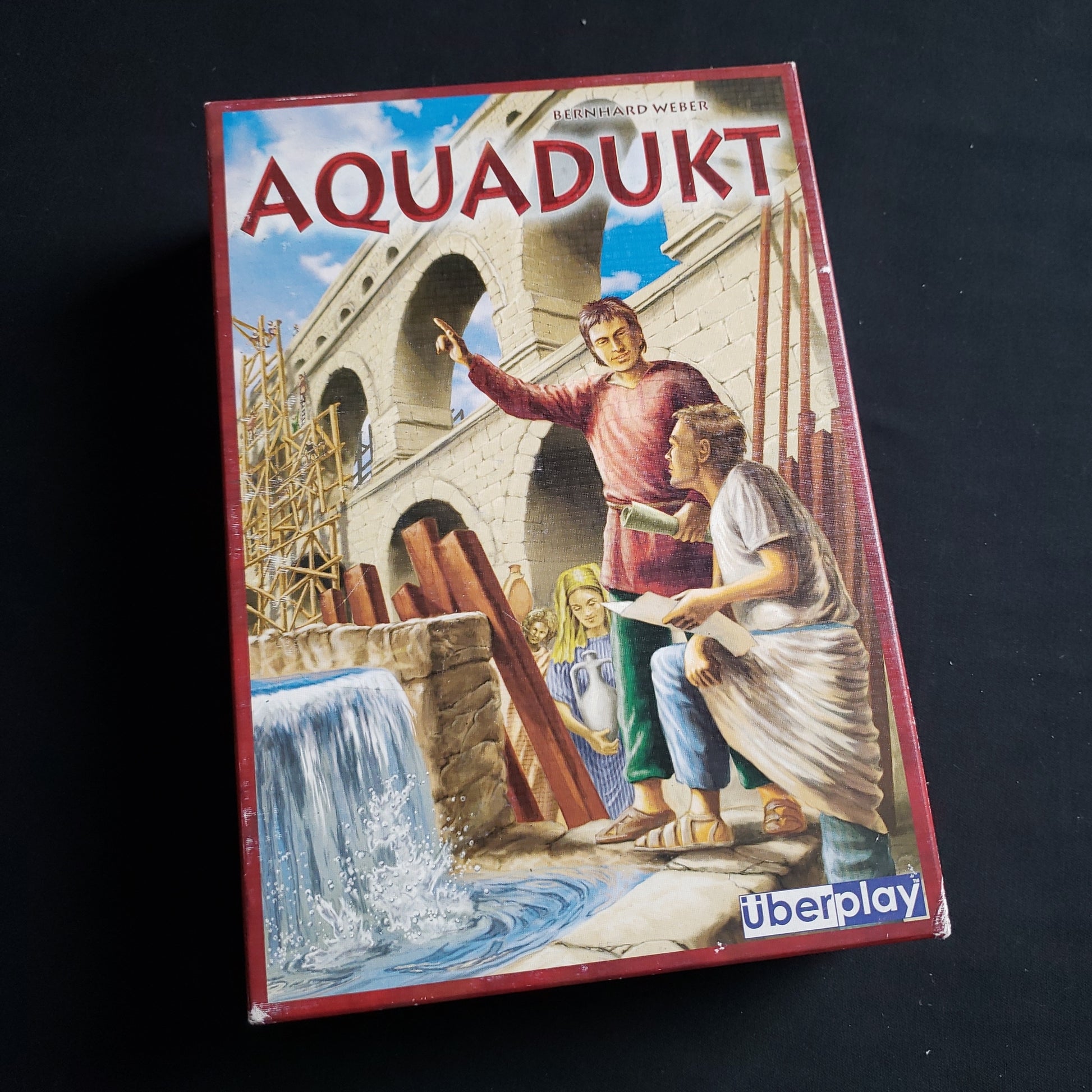 Image shows the front cover of the box of the Aquadukt board game