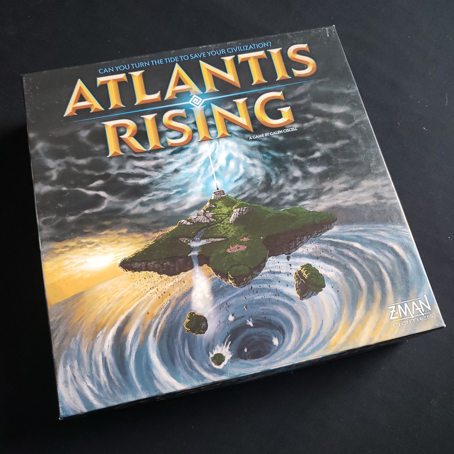 Image shows the front cover of the box of the Atlantis Rising board game
