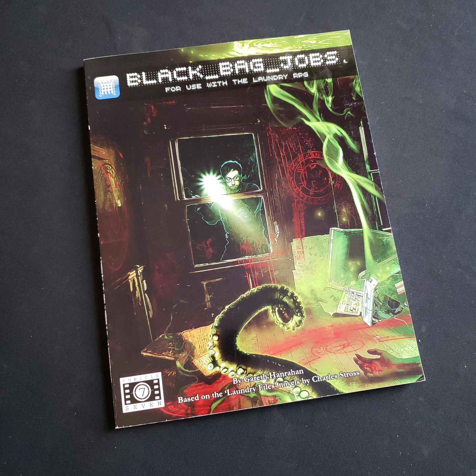 Image shows the front cover of the Black Bag Jobs book for the Laundry roleplaying game
