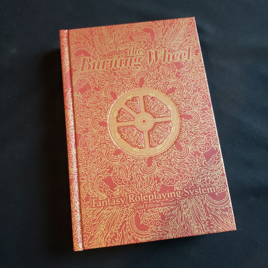 Image shows the front cover of the Burning Wheel: Gold Edition Revised roleplaying game book