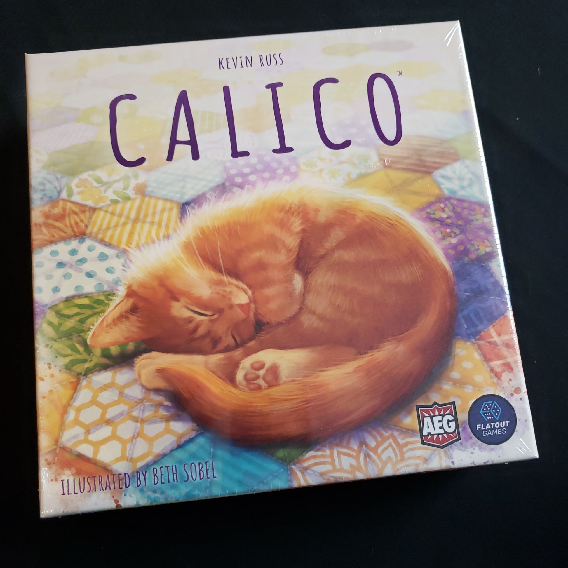 Image shows the front cover of the box of the Calico board game