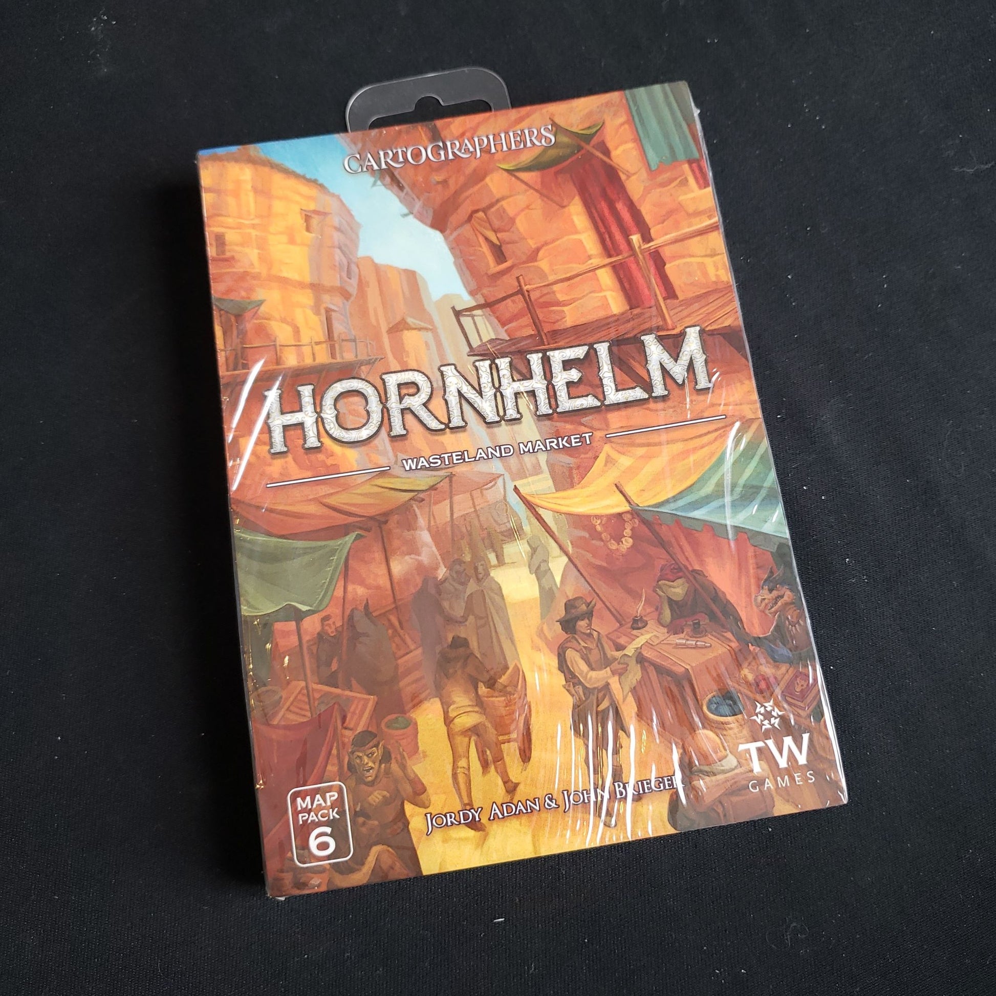 Image shows the front of the package for the Hornhelm Market expansion for the Cartographers game
