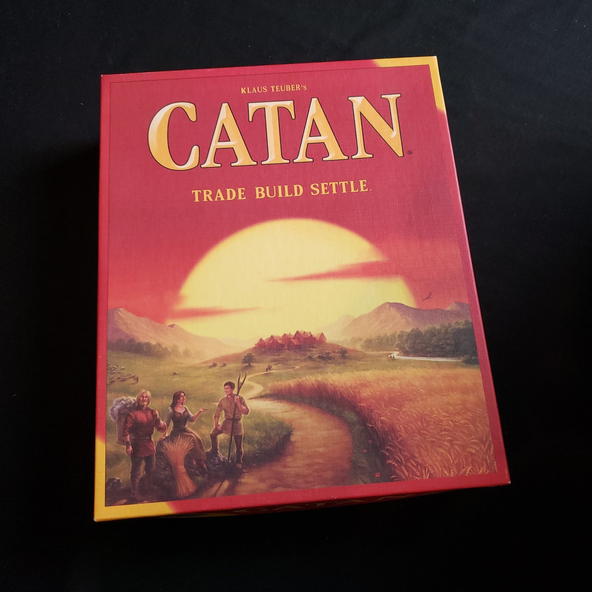 Image shows the front cover of the box of the Catan board game