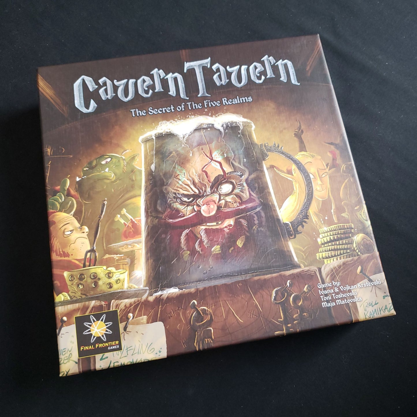 Image shows the front cover of the box of the Cavern Tavern board game