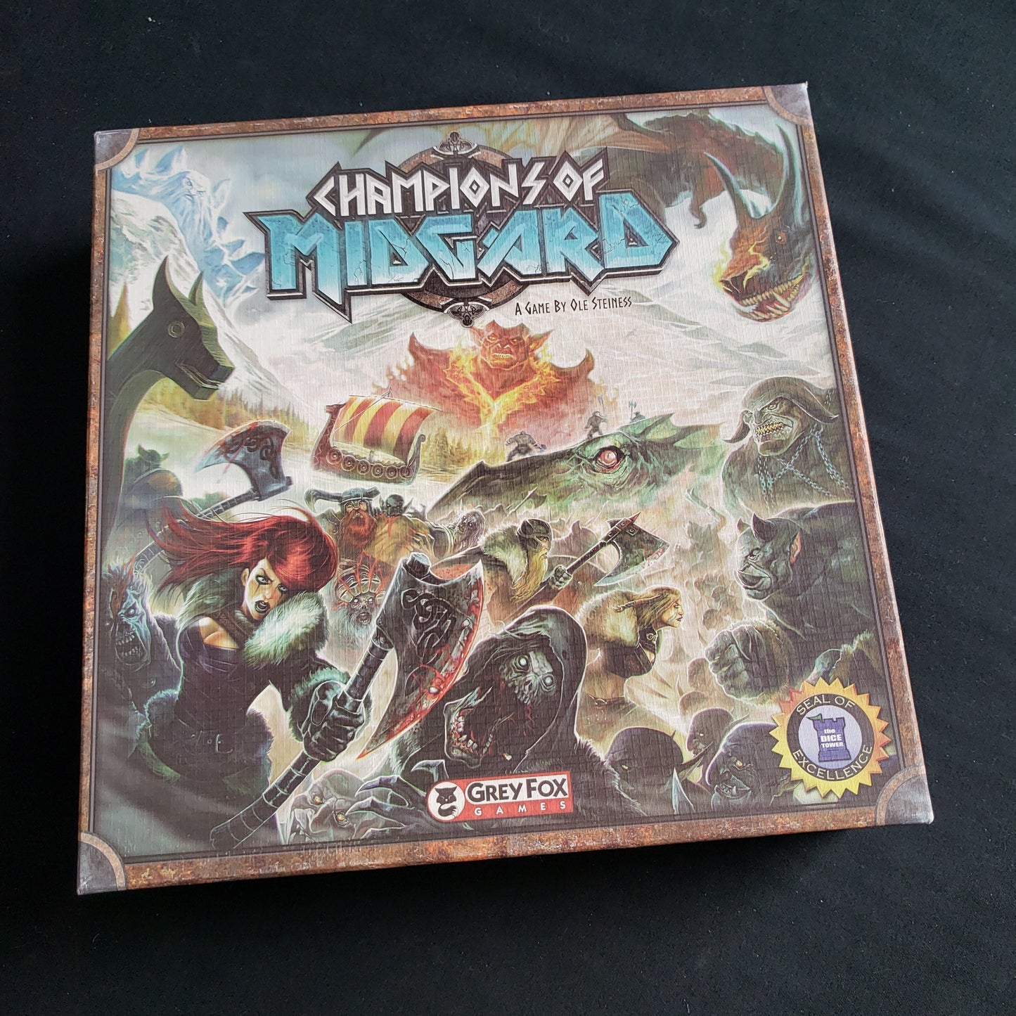 Image shows the front cover of the box of the Champions of Midgard board game