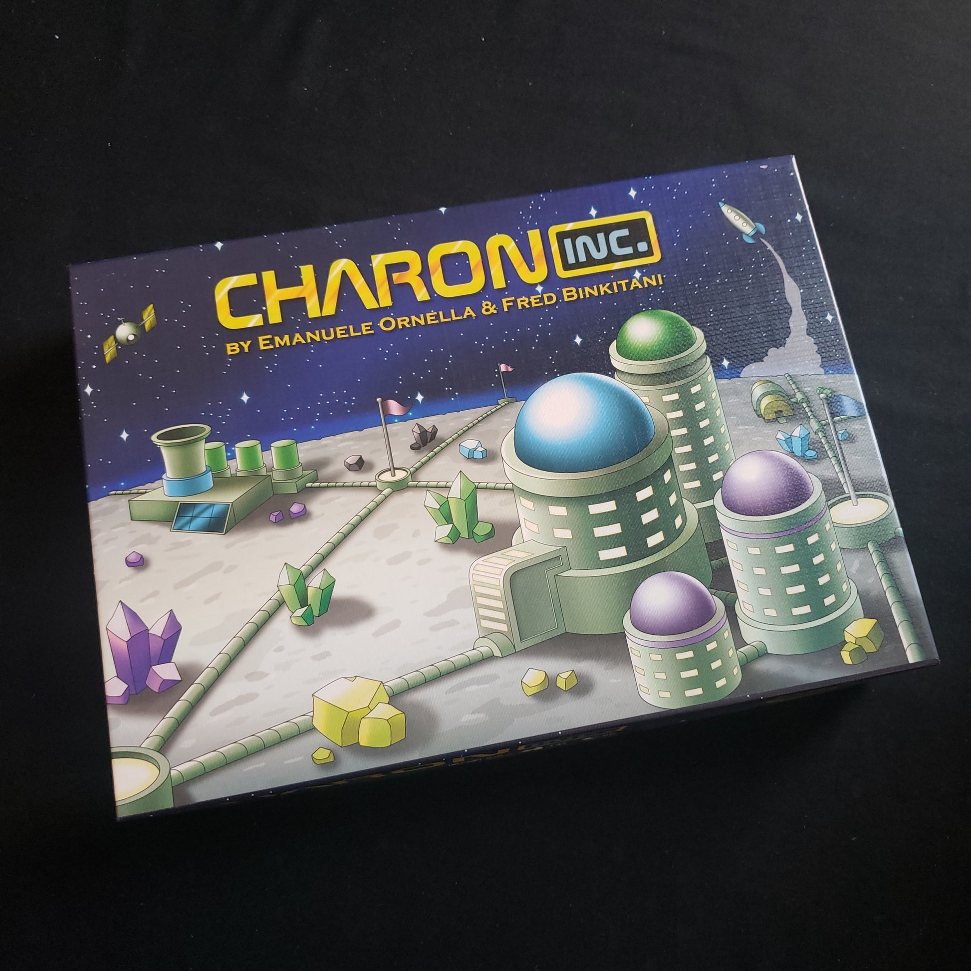 Image shows the front cover of the box of the Charon, Inc. board game