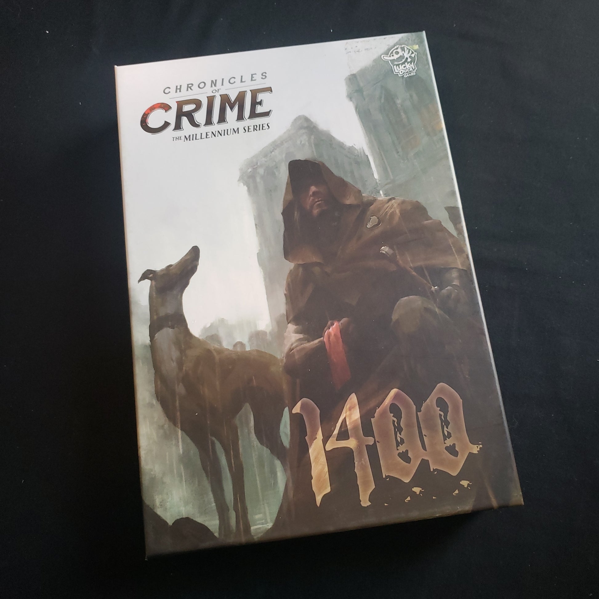 Image shows the front cover of the box of the Chronicles of Crime: 1400 board game