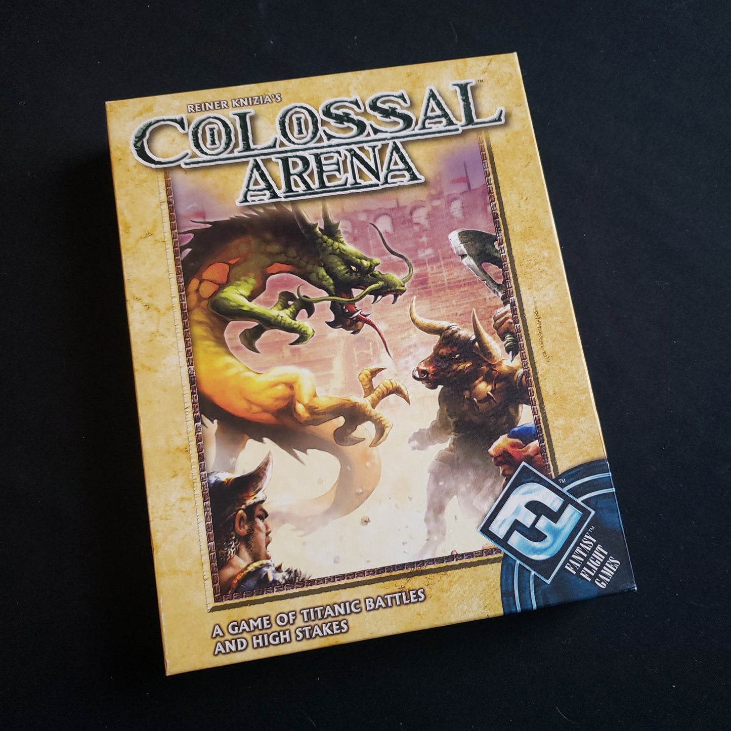 Image shows the front cover of the box of the Colossal Arena card game