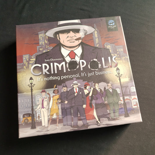 Image shows the front cover of the box of the Crimopolis board game