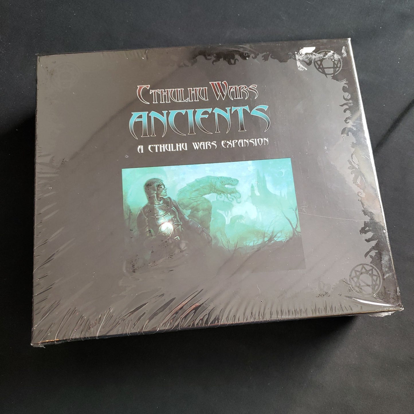Image shows the front cover of the box of the Ancients expansion for the Cthulhu Wars board game