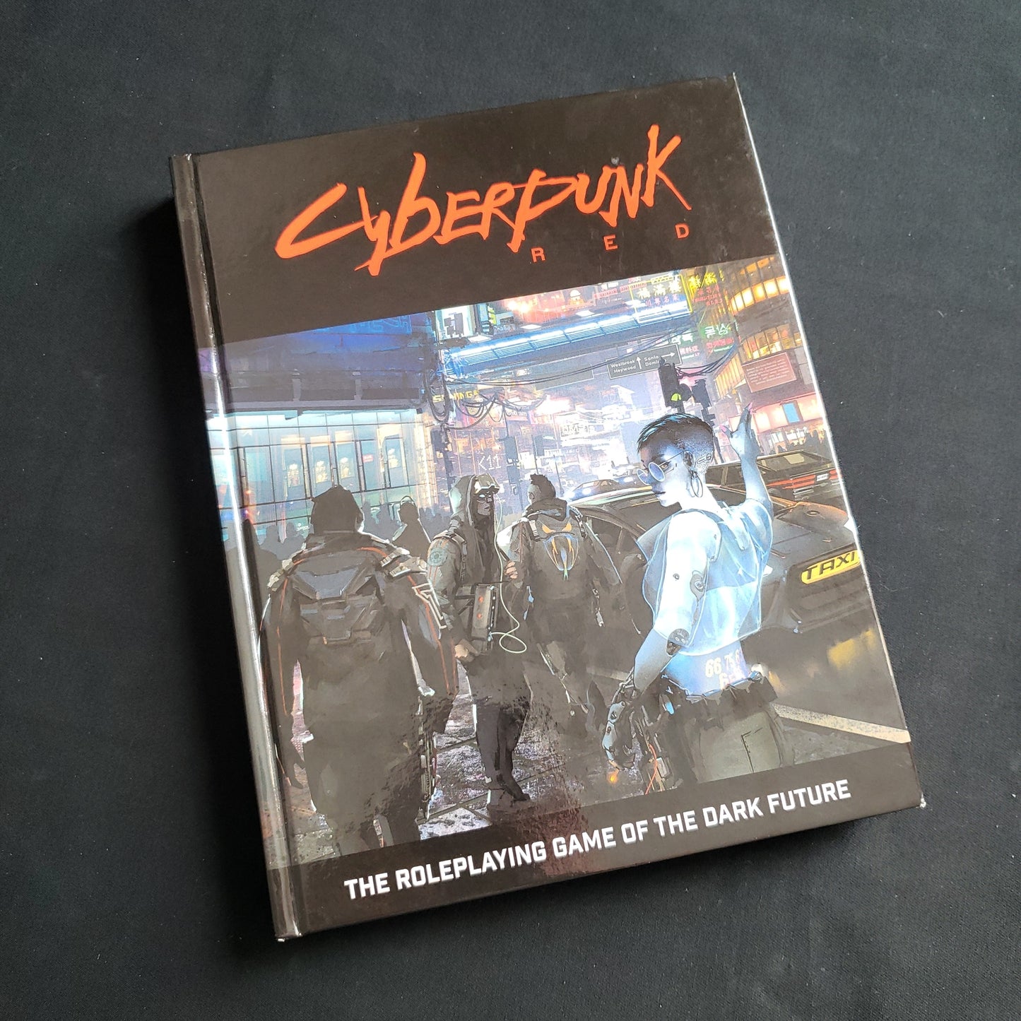 Image shows the front cover of the Cyberpunk RED roleplaying game core rulebook