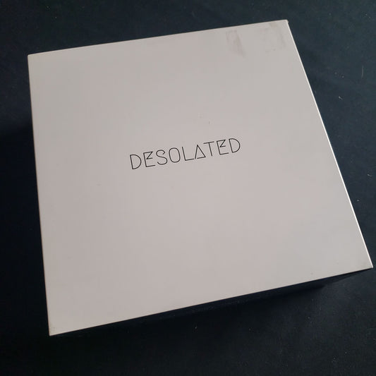 Image shows the front cover of the box of the Desolated board game