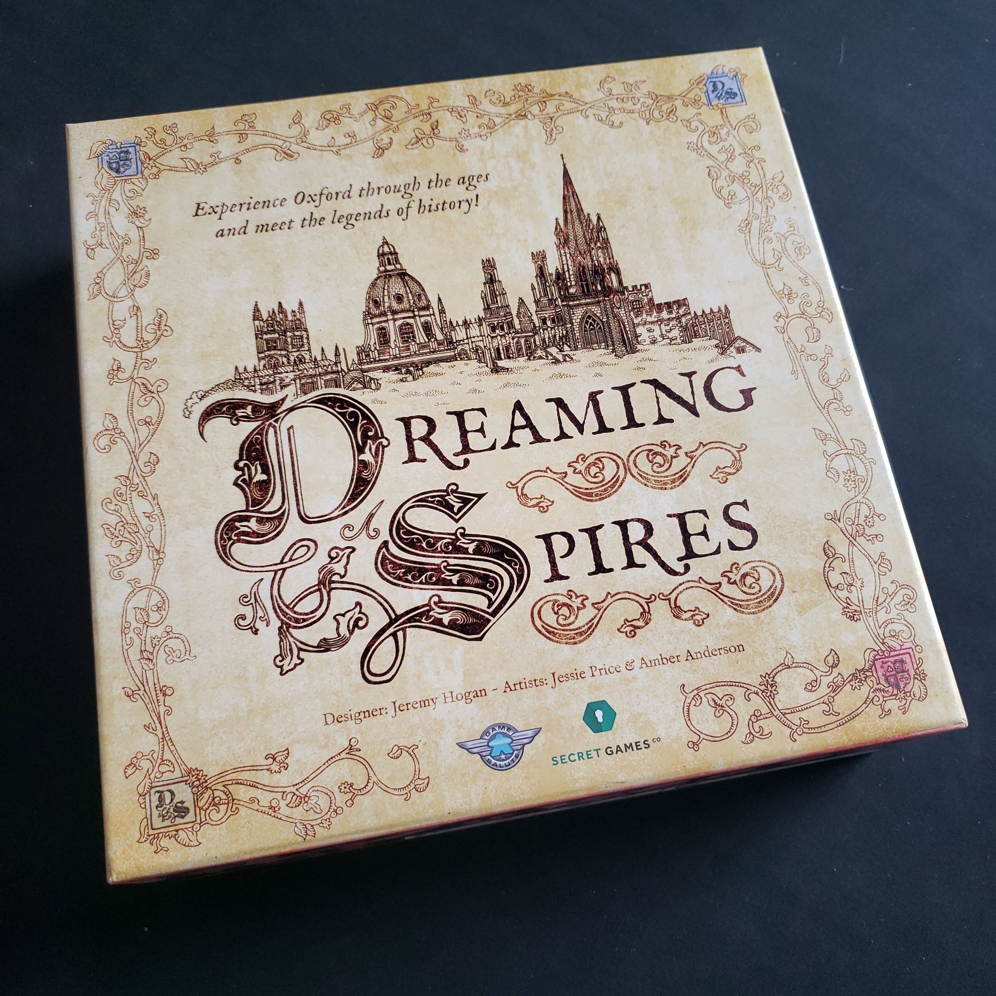 Image shows the front cover of the box of the Dreaming Spires board game