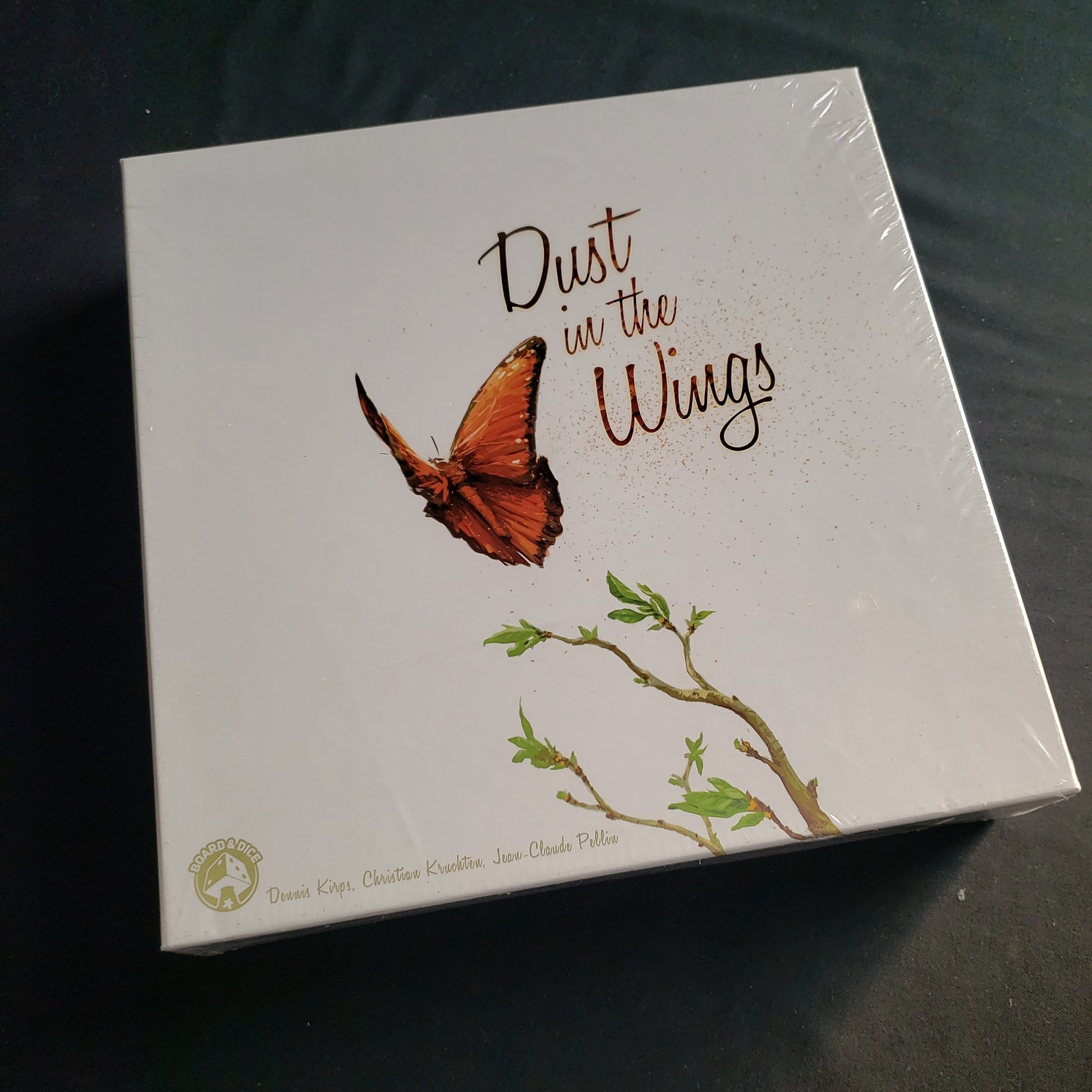 Image shows the front cover of the box of the Dust In The Wings board game