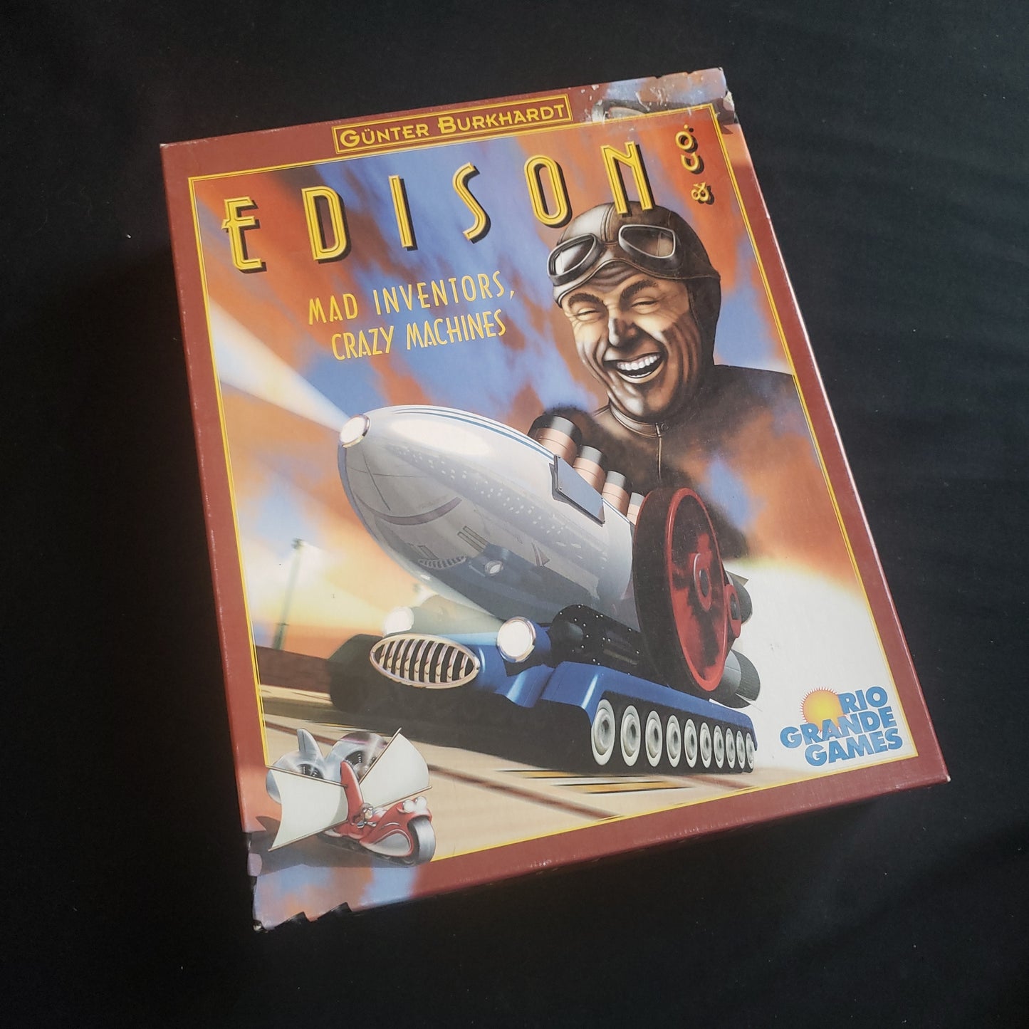 Image shows the front cover of the box of the Edison & Co. board game