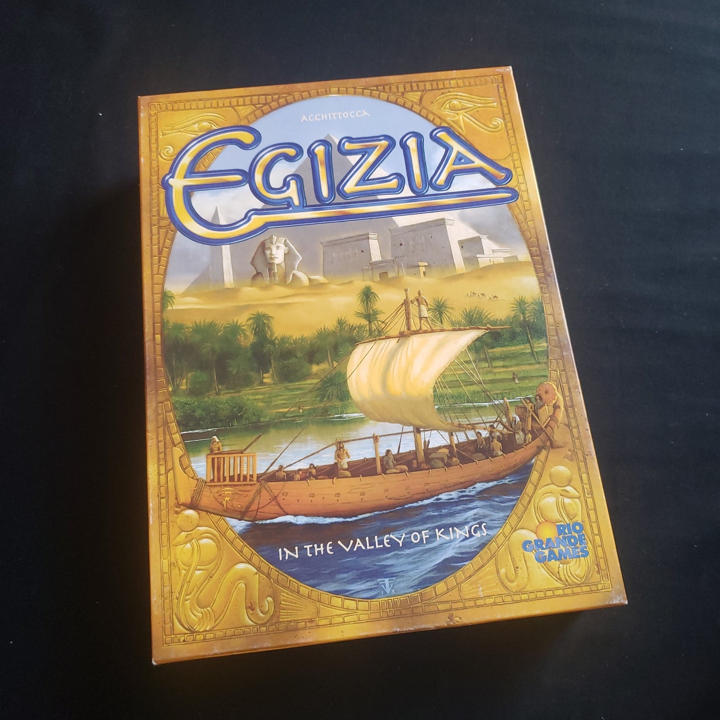 Image shows the front cover of the box of the Egizia board game