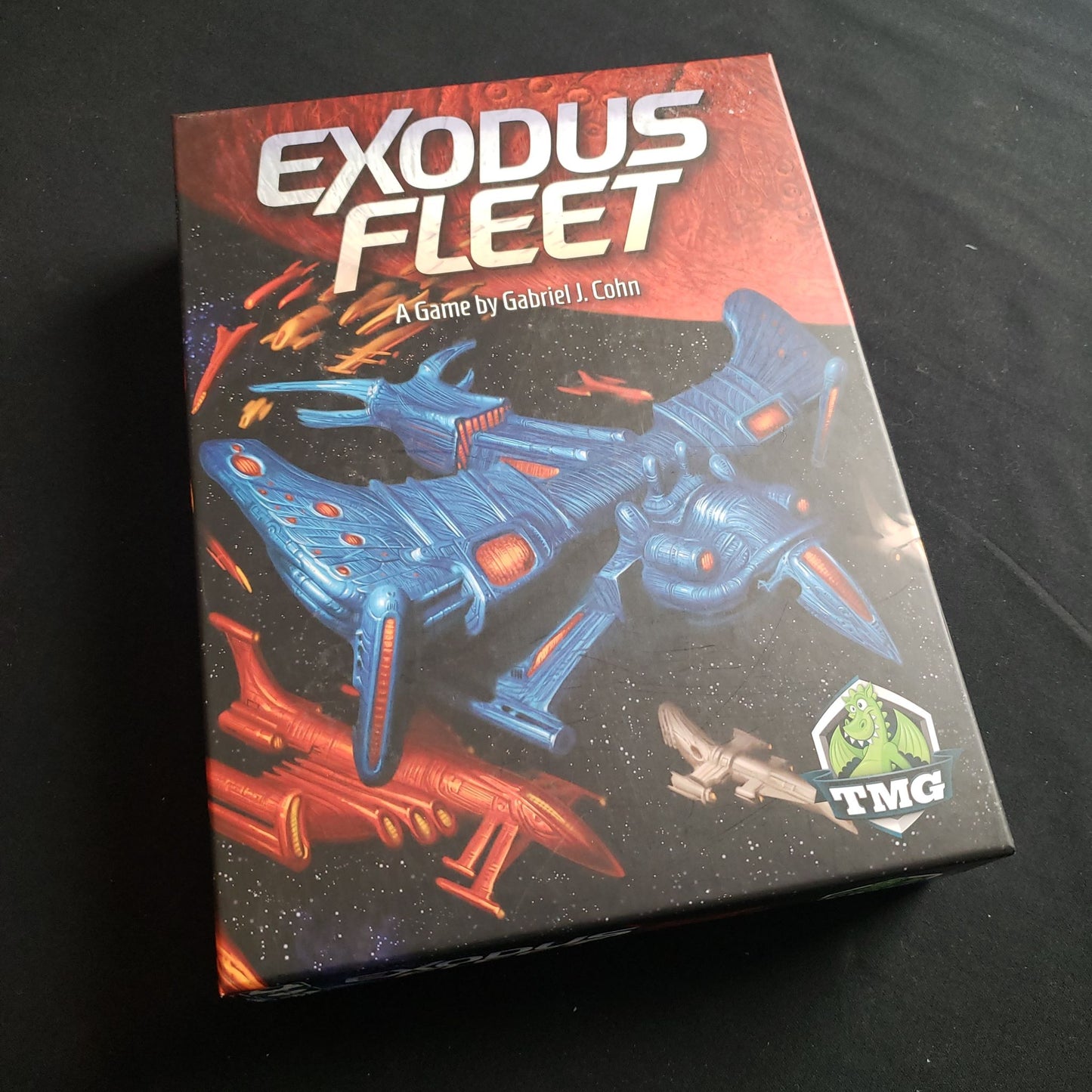 Image shows the front cover of the box of the Exodus Fleet board game
