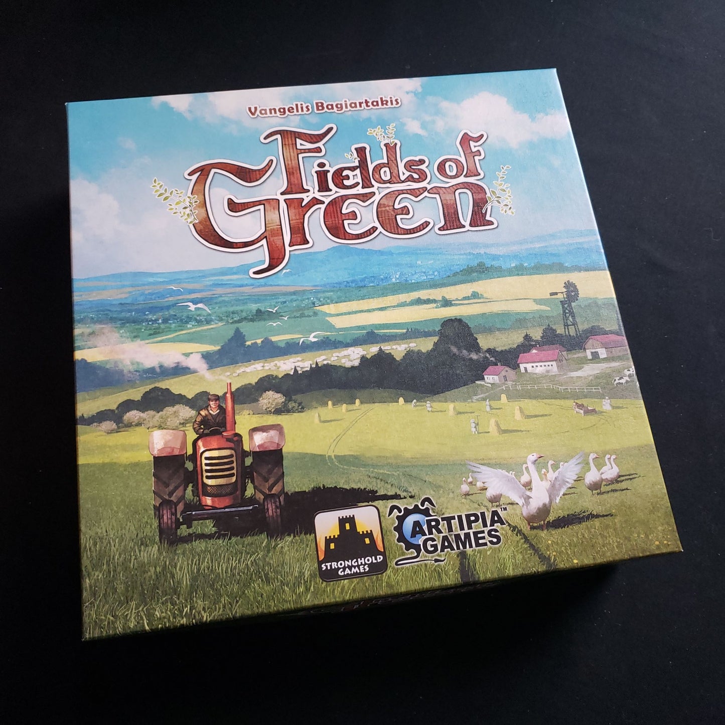 Image shows the front cover of the box of the Fields of Green board game