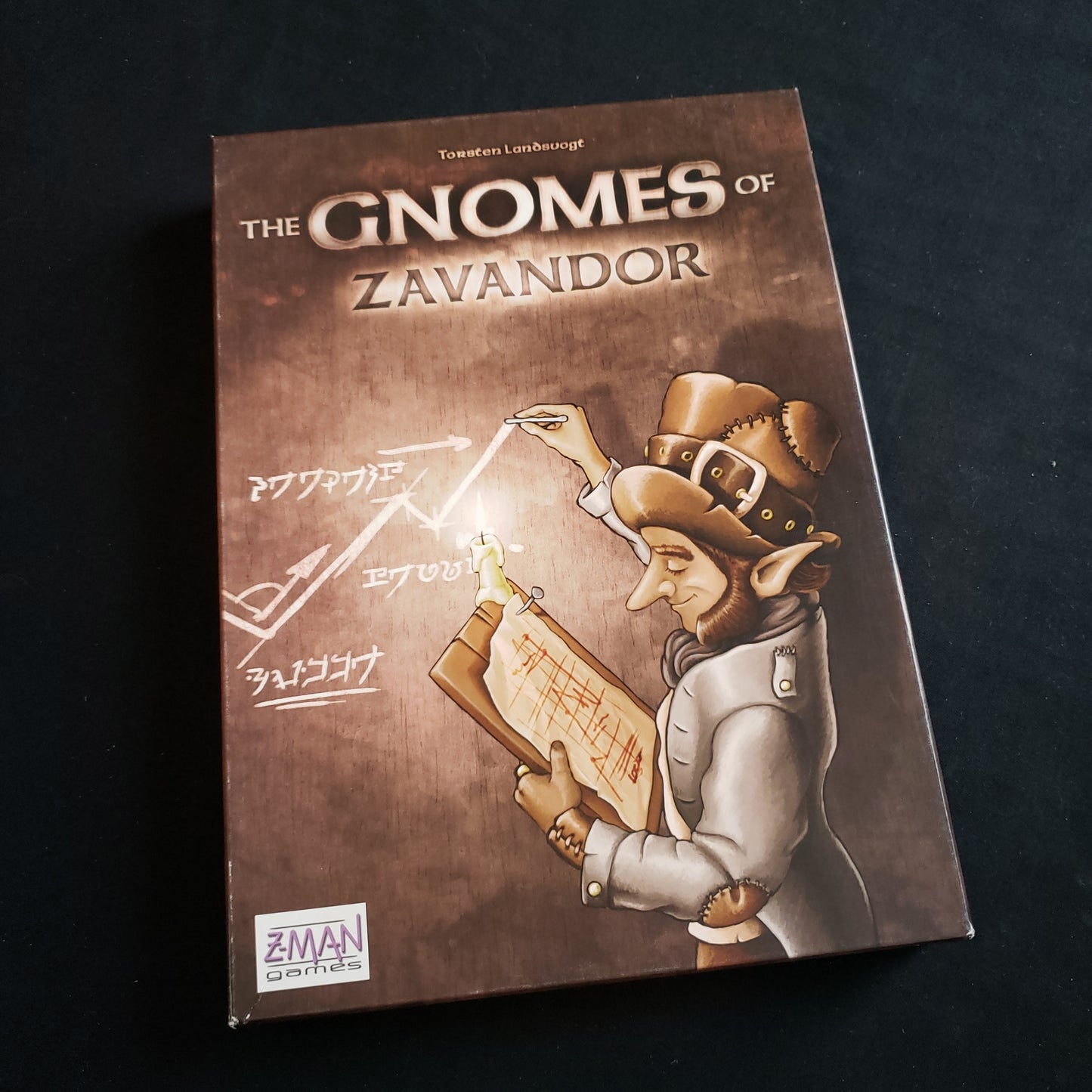 Image shows the front cover of the box of the Gnomes of Zavandor board game
