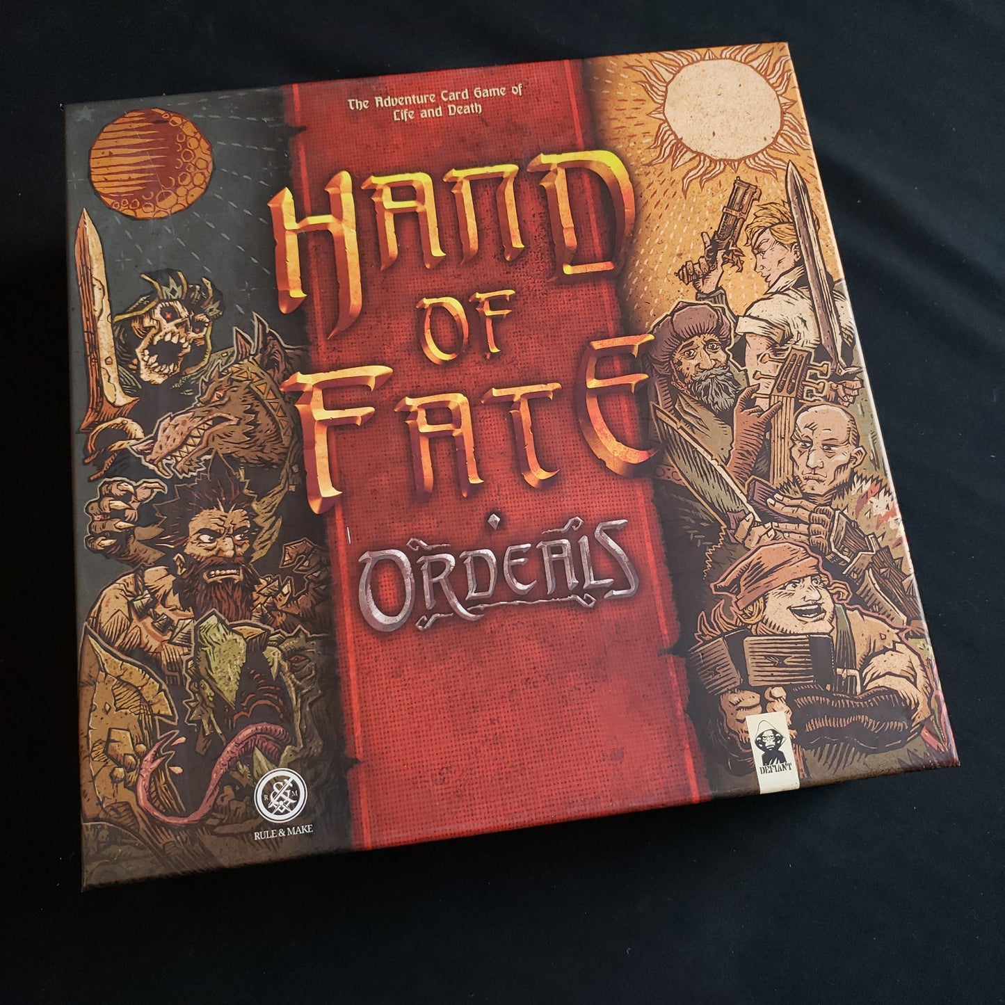 Image shows the front cover of the box of the Hand of Fate: Ordeals board game