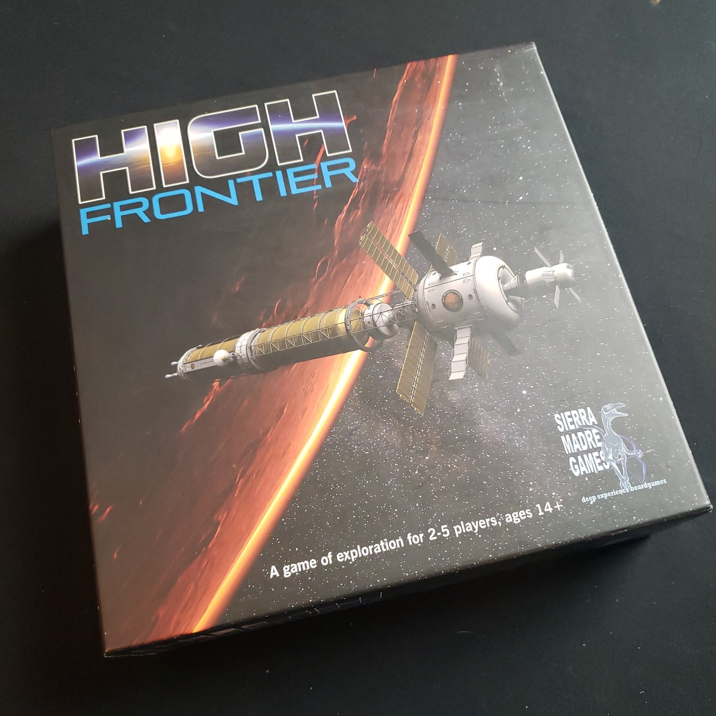 Image shows the front cover of the box of the High Frontier board game