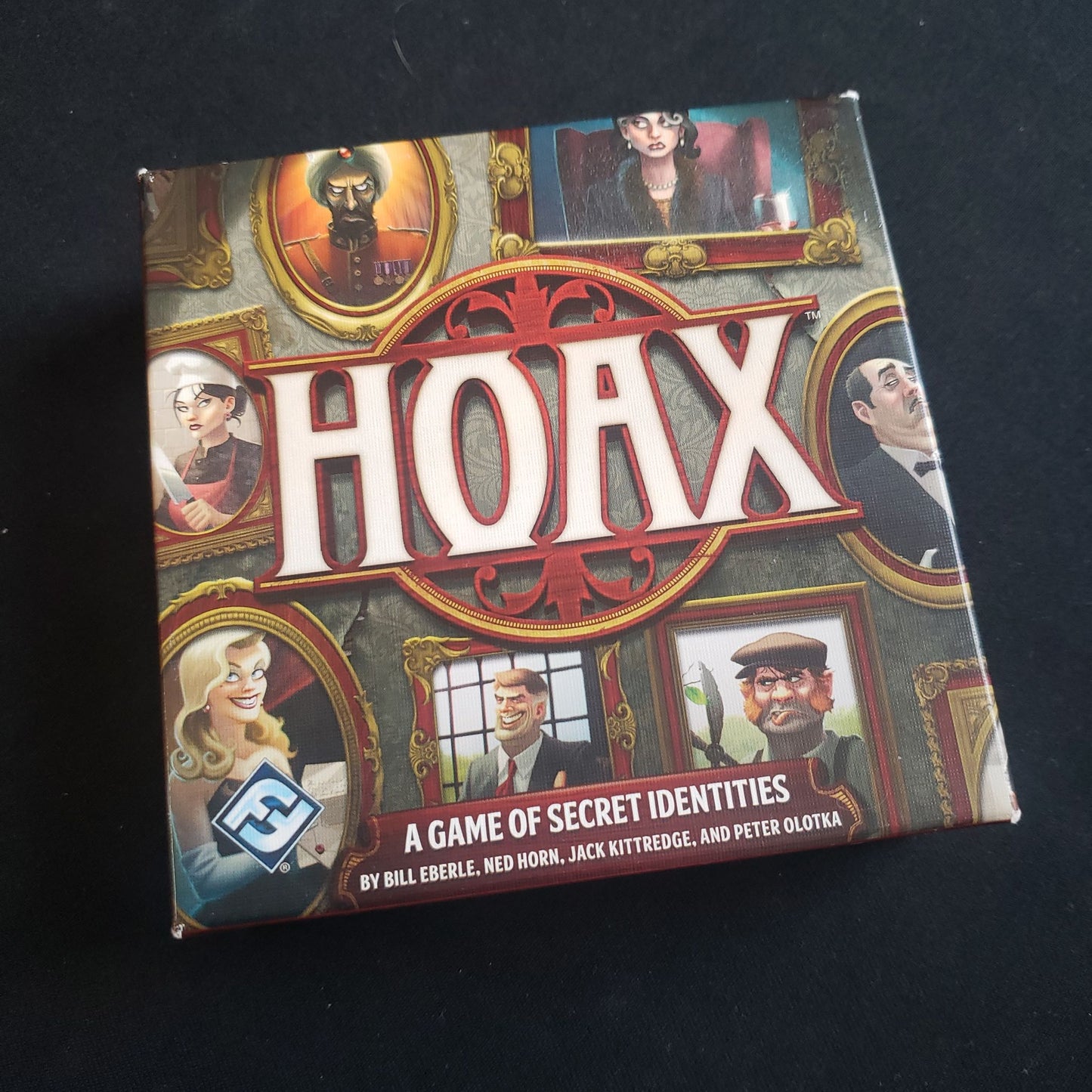 Image shows the front cover of the box of the Hoax card game