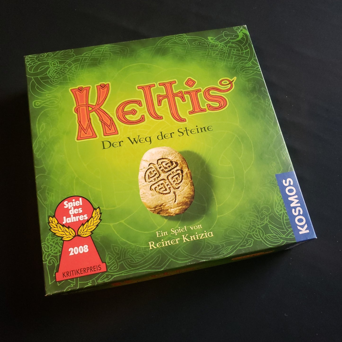Image shows the front cover of the box of the Keltis board game