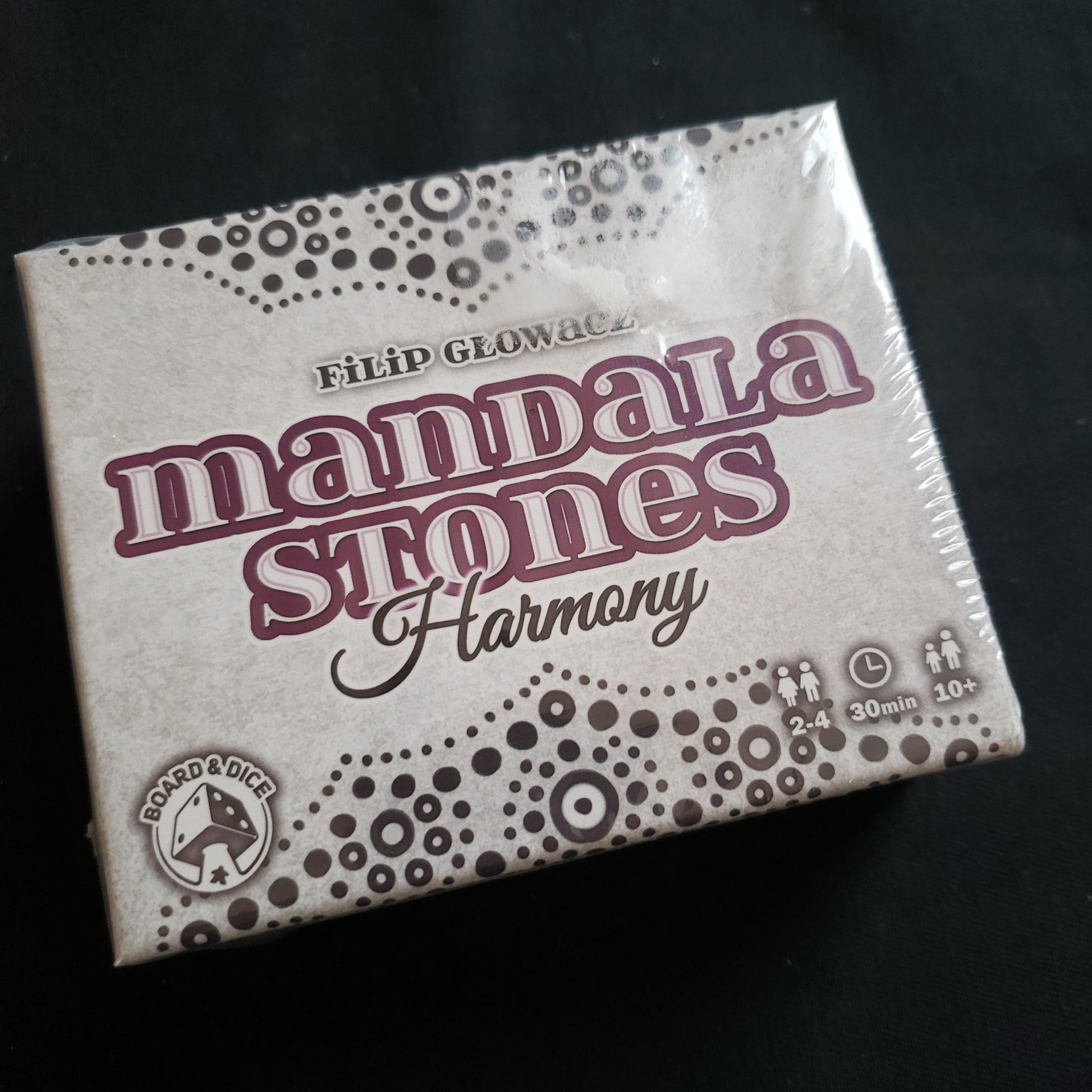 Image shows the front cover of the box of the harmony expansion for the Mandala Stones board game