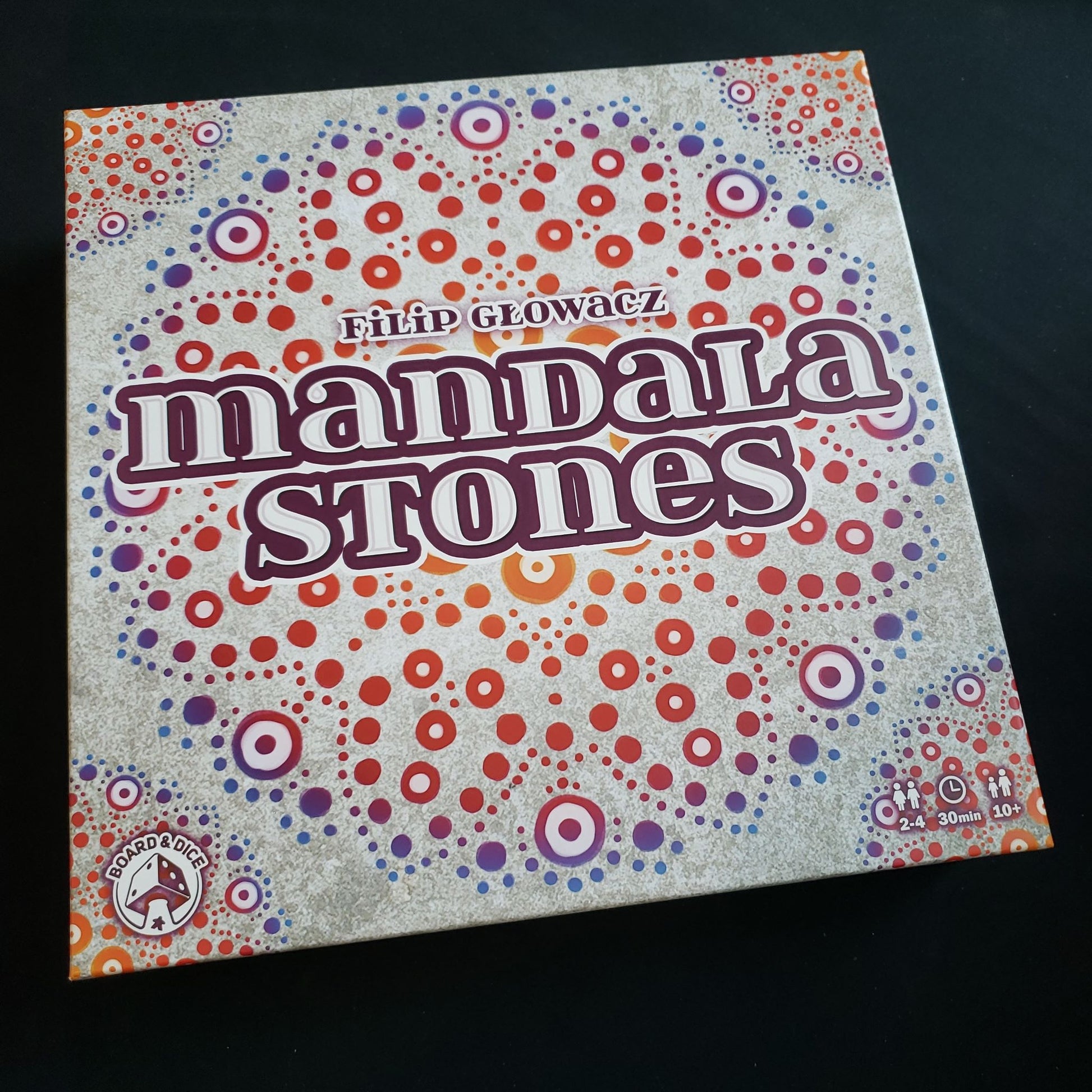 Image shows the front cover of the box of the Mandala Stones board game