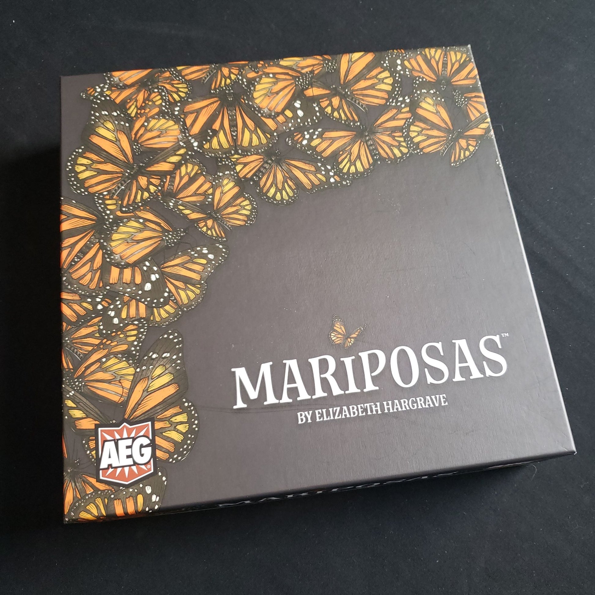 Image shows the front cover of the box of the Mariposas board game