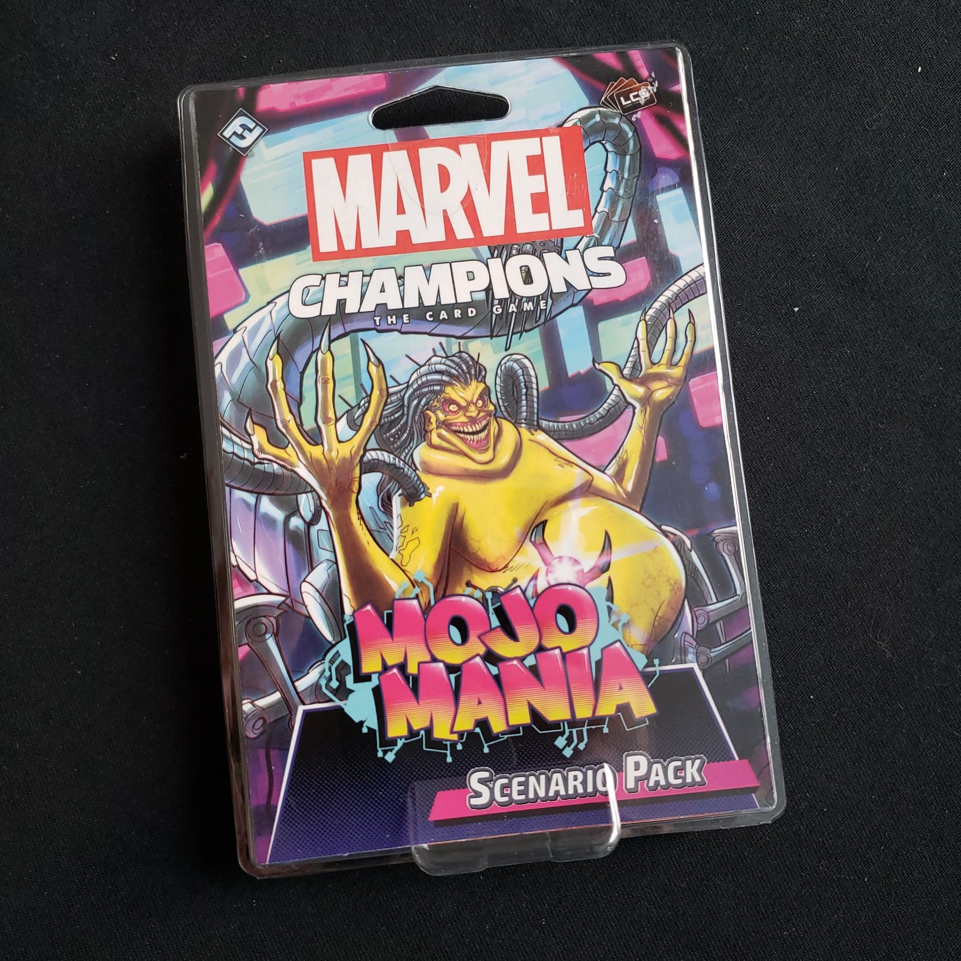 Image shows the front of the package for the MojoMania Scenario Pack for the Marvel Champions card game