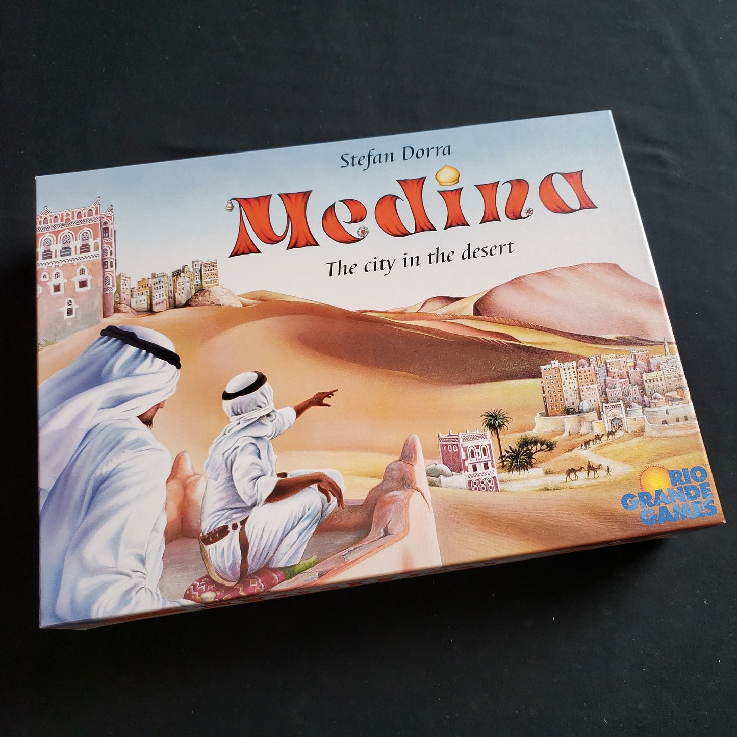 Image shows the front cover of the box of the Medina board game