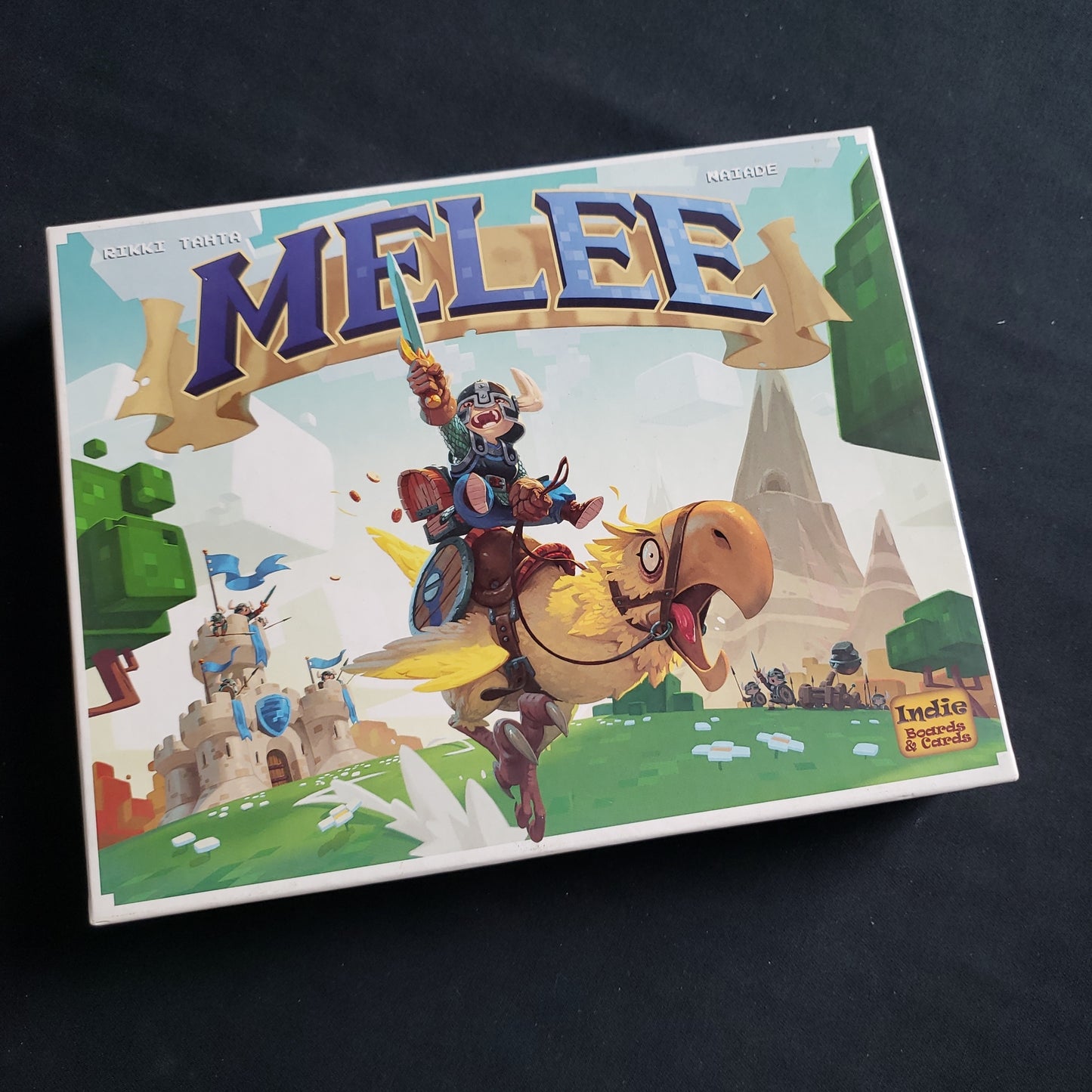 Image shows the front cover of the box of the Melee board game